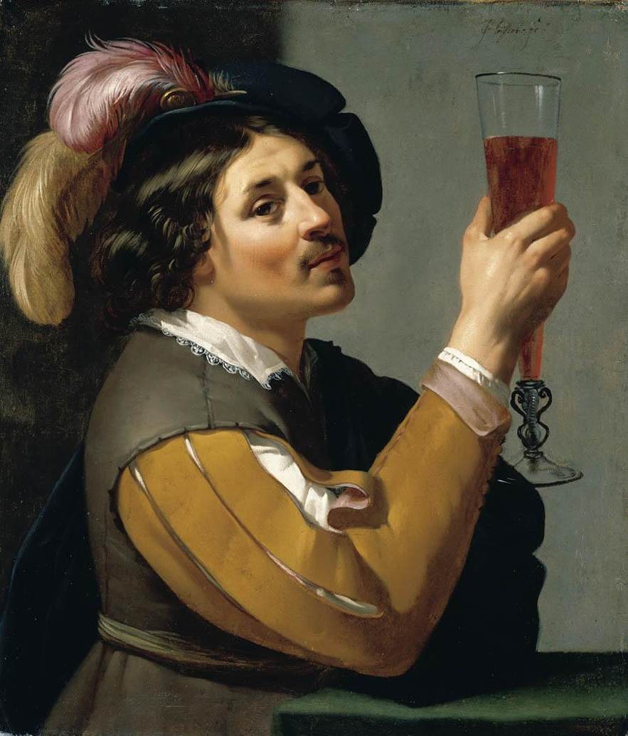 Young Man Drinking a Glass of Wine by